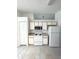 Functional kitchen offers white appliances, cabinetry, and durable tile flooring at 2524 Daffadil Ter, Sanford, FL 32771