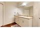 Bathroom vanity featuring granite countertops, double sinks, and hardwood floors at 2901 Edenshire Way # 102, Kissimmee, FL 34746