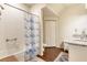 Bathroom with tiled shower, vanity with granite countertop, and tile floors at 2901 Edenshire Way # 102, Kissimmee, FL 34746