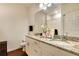 Bathroom featuring granite countertops, double sinks, and hardwood floors at 2901 Edenshire Way # 102, Kissimmee, FL 34746