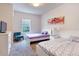 Bright bedroom featuring two twin beds, a dresser, and a window at 2901 Edenshire Way # 102, Kissimmee, FL 34746