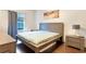 This bedroom features a bed, hardwood floors, and a window at 2901 Edenshire Way # 102, Kissimmee, FL 34746