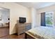 Bedroom with hardwood floors featuring a television on a dresser at 2901 Edenshire Way # 102, Kissimmee, FL 34746