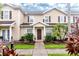 Charming townhome featuring a well-maintained front yard with lush tropical landscaping at 2901 Edenshire Way # 102, Kissimmee, FL 34746
