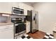 Well-equipped kitchen with modern stainless steel appliances and tile backsplash at 2901 Edenshire Way # 102, Kissimmee, FL 34746
