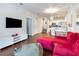 Spacious living room with hardwood floors, an open floor plan, and plenty of natural light at 2901 Edenshire Way # 102, Kissimmee, FL 34746