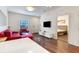 Cozy living area with hardwood floors, access to a bedroom and dining area at 2901 Edenshire Way # 102, Kissimmee, FL 34746
