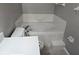 Bathroom features a corner tub with white tile surround, a toilet, and a white countertop at 304 Lake Daisy Loop, Winter Haven, FL 33884