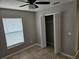 Neutral bedroom with a closet, ceiling fan, window, and tile flooring at 304 Lake Daisy Loop, Winter Haven, FL 33884