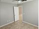 Bedroom features neutral walls, tile flooring, and an open door leading to another room at 304 Lake Daisy Loop, Winter Haven, FL 33884