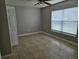 Bedroom features tile flooring, neutral walls, a large window with blinds and a closet at 304 Lake Daisy Loop, Winter Haven, FL 33884