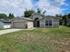 Charming single-story home with a two-car garage and well-manicured lawn on a sunny day at 304 Lake Daisy Loop, Winter Haven, FL 33884