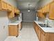 Bright, galley-style kitchen featuring light wood cabinets, marble countertops, and open layout at 304 Lake Daisy Loop, Winter Haven, FL 33884