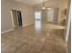 Open-concept living room featuring tile floors, high ceilings, and lots of natural light at 304 Lake Daisy Loop, Winter Haven, FL 33884