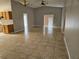 Open-concept living room features tile floors, neutral walls, and an open layout to the kitchen at 304 Lake Daisy Loop, Winter Haven, FL 33884