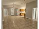 Open-concept living room features tile floors, neutral walls, and an open layout to the kitchen at 304 Lake Daisy Loop, Winter Haven, FL 33884