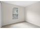 Bright bedroom features a window and neutral carpeting at 307 Monterey St, Kissimmee, FL 34759