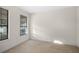 Bedroom featuring two windows with blinds, neutral walls, and carpet floors at 307 Monterey St, Kissimmee, FL 34759