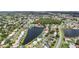 Stunning aerial view of a lakeside home surrounded by lush greenery at 344 Blue Bayou Dr, Kissimmee, FL 34743