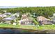 Aerial view of the property showing a lake view, screen-in pool and mature trees at 344 Blue Bayou Dr, Kissimmee, FL 34743