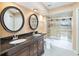 Bathroom featuring double sinks, granite countertop, and a tiled shower/tub combo at 344 Blue Bayou Dr, Kissimmee, FL 34743