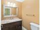 Bathroom with vanity, granite countertop, and silver framed mirror at 344 Blue Bayou Dr, Kissimmee, FL 34743