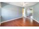 Bedroom with a ceiling fan, light blue walls, hardwood floors and mirrored closet doors at 344 Blue Bayou Dr, Kissimmee, FL 34743