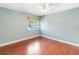 Bedroom with a ceiling fan, light blue walls, hardwood floors and a window view at 344 Blue Bayou Dr, Kissimmee, FL 34743
