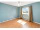 Bedroom with a ceiling fan, hardwood floors, and a window overlooking the neighborhood at 344 Blue Bayou Dr, Kissimmee, FL 34743