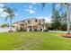 Beautiful two-story home with a well-manicured lawn and mature palm trees at 344 Blue Bayou Dr, Kissimmee, FL 34743