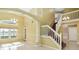 Bright and spacious foyer with high ceilings, a staircase, and large windows at 344 Blue Bayou Dr, Kissimmee, FL 34743