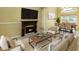 Comfortable living room featuring a fireplace and a dining area with lake views at 344 Blue Bayou Dr, Kissimmee, FL 34743