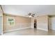 Bright living room featuring tile flooring, paneled walls, and a ceiling fan with lights at 344 Blue Bayou Dr, Kissimmee, FL 34743