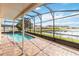 Home's screened-in pool area overlooking a calming lake at 344 Blue Bayou Dr, Kissimmee, FL 34743