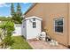 Home's backyard featuring a white storage shed, lush lawn, and a brick pathway at 344 Blue Bayou Dr, Kissimmee, FL 34743