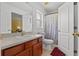 Bathroom featuring a single sink, vanity, and a shower/tub combination with a white and grey shower curtain at 36646 Oconee Ave, Eustis, FL 32736