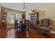 Formal dining room featuring hardwood floors, traditional furniture, and ample natural light from the window at 36646 Oconee Ave, Eustis, FL 32736