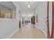 Open foyer leading to a spacious living area, featuring neutral tile flooring and views of the well-lit interior at 36646 Oconee Ave, Eustis, FL 32736