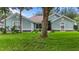 Charming one-story home featuring a lush green lawn and inviting curb appeal with stone accents and mature trees at 36646 Oconee Ave, Eustis, FL 32736