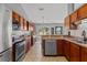 Bright kitchen features stainless steel appliances, wood cabinets, and natural light at 36646 Oconee Ave, Eustis, FL 32736