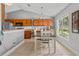 Eat-in kitchen featuring wood cabinets, grey walls, stainless appliances, and a breakfast nook area at 36646 Oconee Ave, Eustis, FL 32736