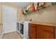 A laundry room equipped with a modern washer and dryer, storage shelves, and a folding counter at 36646 Oconee Ave, Eustis, FL 32736