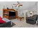 Comfortable living room featuring tile flooring, ceiling fan, and entertainment center with furniture at 36646 Oconee Ave, Eustis, FL 32736