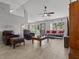 Bright living room with tile floors, ceiling fan, and comfortable seating arrangement with natural light at 36646 Oconee Ave, Eustis, FL 32736