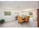 Bright dining area with a large window and a contemporary table set, offering views of the outdoors at 3950 Alba Dr, Indian Lake Estates, FL 33855