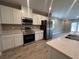 Modern kitchen with stainless steel appliances, sleek countertops, and ample cabinet space at 3950 Alba Dr, Indian Lake Estates, FL 33855