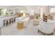 Inviting living area with white sofa, barstool seating at the kitchen island, and neutral decor to create an open and airy space at 3950 Alba Dr, Indian Lake Estates, FL 33855