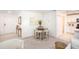 Open-concept living room with neutral carpet, dining area, and access to the kitchen at 3950 Alba Dr, Indian Lake Estates, FL 33855