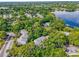 Aerial view showcasing a lakeside community with mature trees, swimming pool, and well-maintained landscaping at 4102 Plantation Cove Dr # 201, Orlando, FL 32810