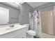 Well-lit bathroom with a single vanity and tub-shower combination with stylish curtain at 4102 Plantation Cove Dr # 201, Orlando, FL 32810